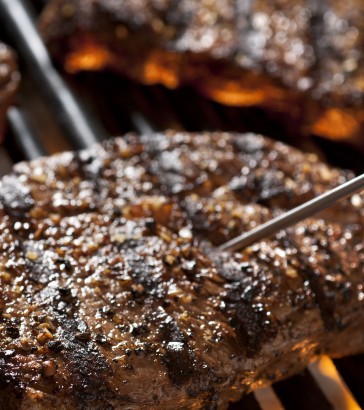 steak on a grill with meat thermometer steak on a grill with meat thermometer