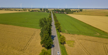fields, road and wind turbines
