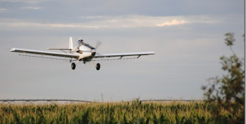 crop dusting plane over a field