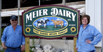 Meiers standing at dairy sign