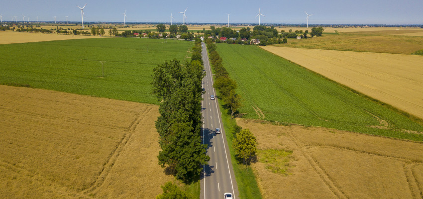 fields, road and wind turbines