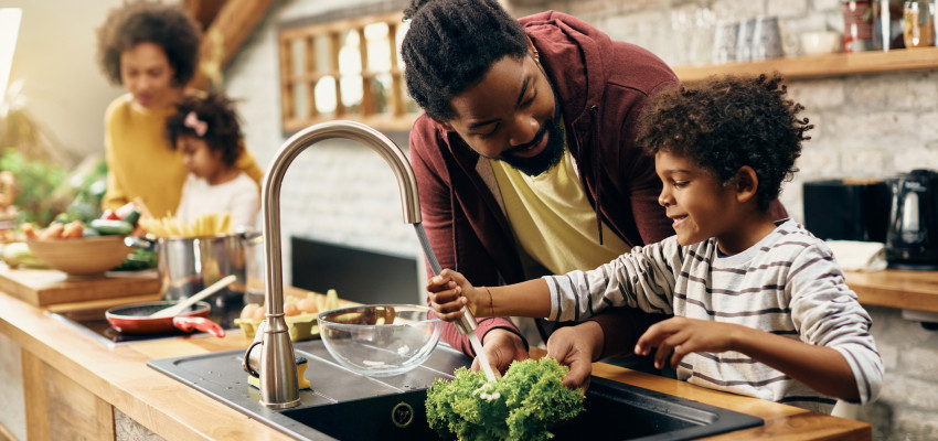 dad and son washing lettuce