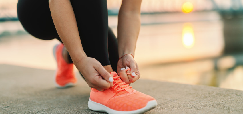 Woman tying shoes