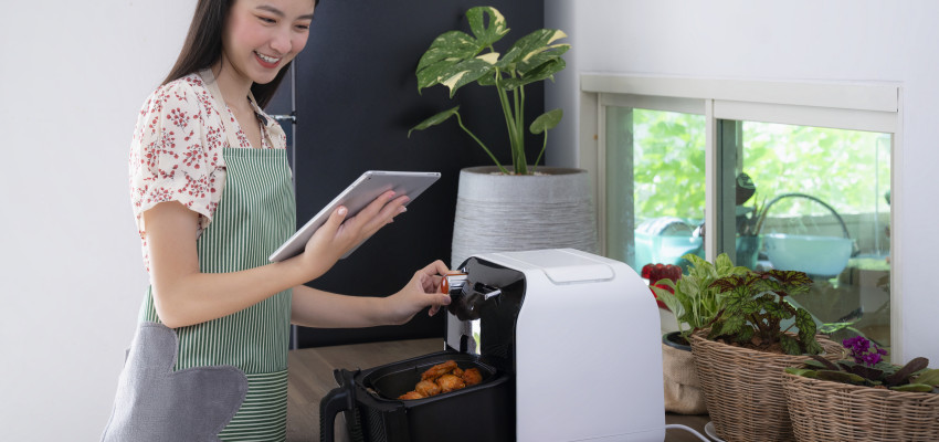 Woman using air fryer Woman using air fryer