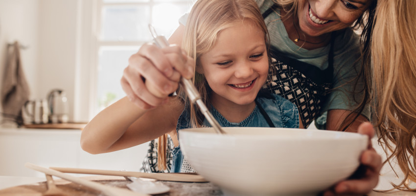 mom and daughter mixing ingredients