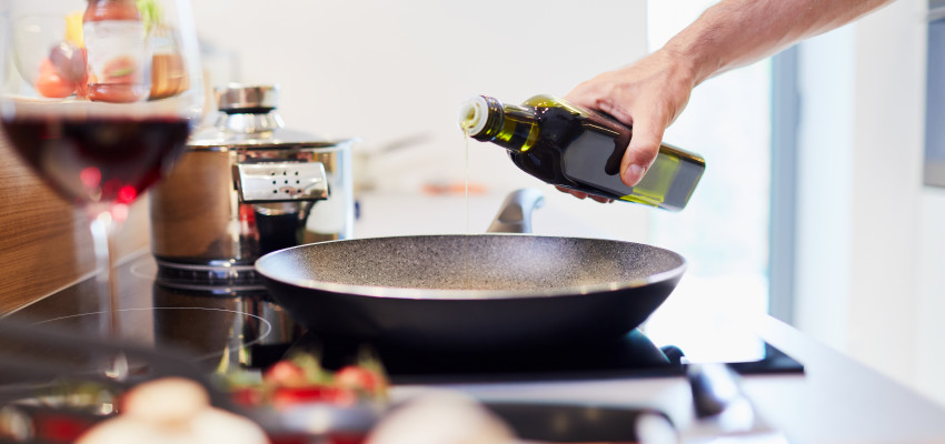 Man Pouring Oil in Hot Pan