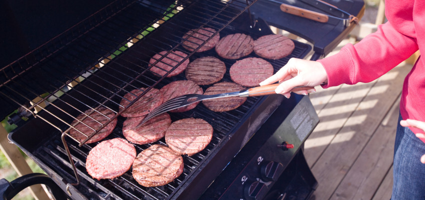 woman grilling hamburgers