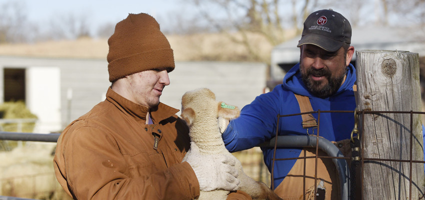 farmers with lamb Isaac and Glenn Brunkow