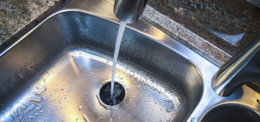 water running down kitchen sink into garbage disposal