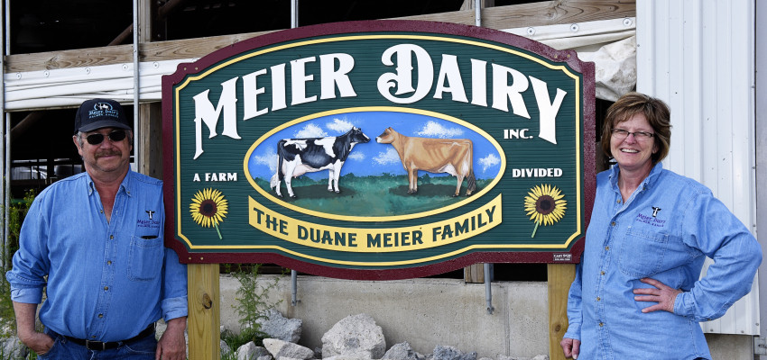 Meiers standing at dairy sign