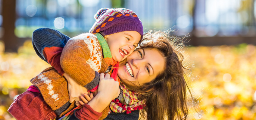 mom and daughter having fun in the fall