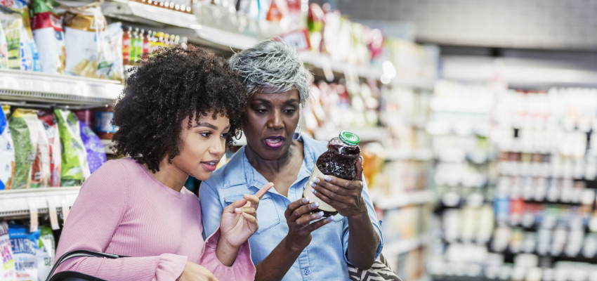 women reading food labels