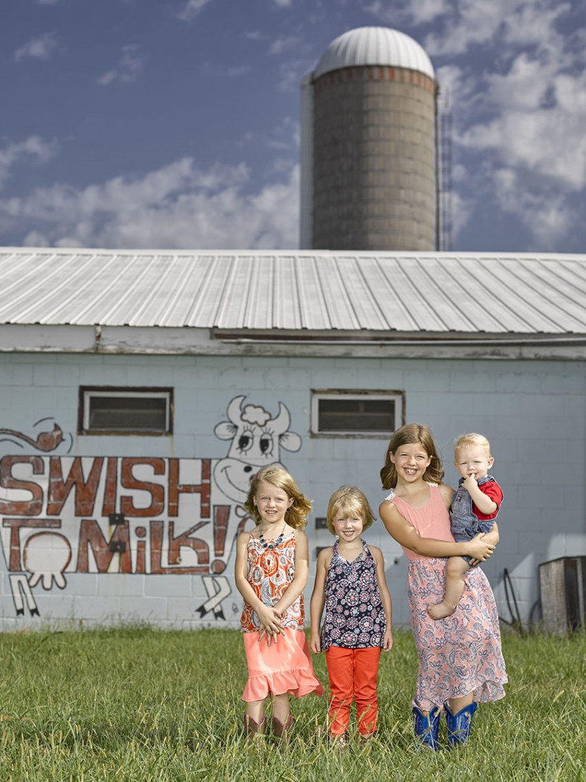 kids in front of milk sign