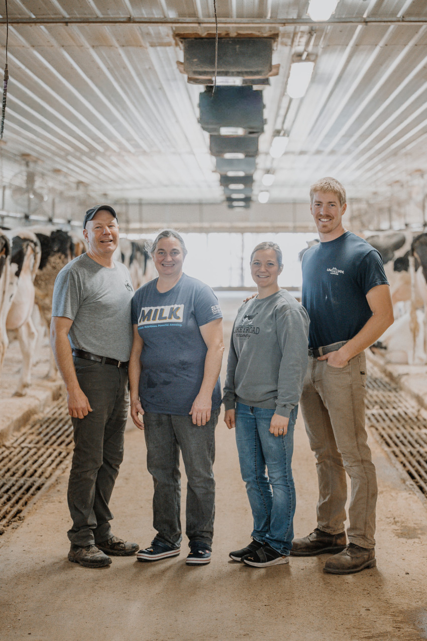 Dwight and Anita Rokey stand with their daughter Leigha and her husband, Jason, in the milking parlor at Rokeyroad Creamery in Sabetha.