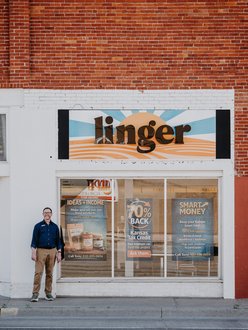 Tony Coast of Linger Gig Lab in Cimarron with the outdoor sign