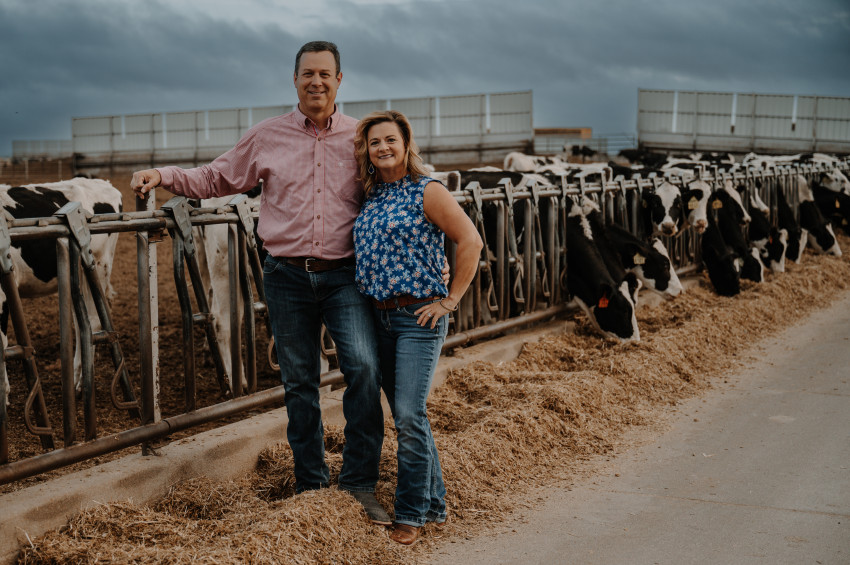 kells family in front of replacement dairy heifers