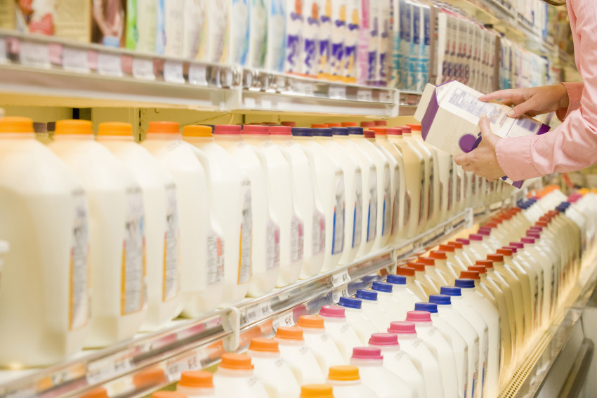 Grocery store shopper looks at a dairy product's food label