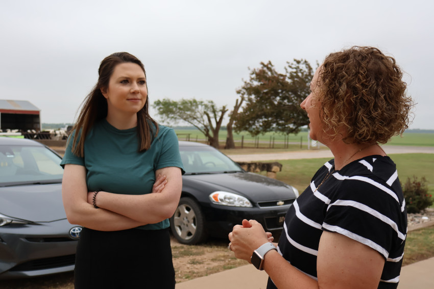 Eryn Carter with KSDE and Heidi Wells, a dairy farmer, visit about ways to bring local products to local schools