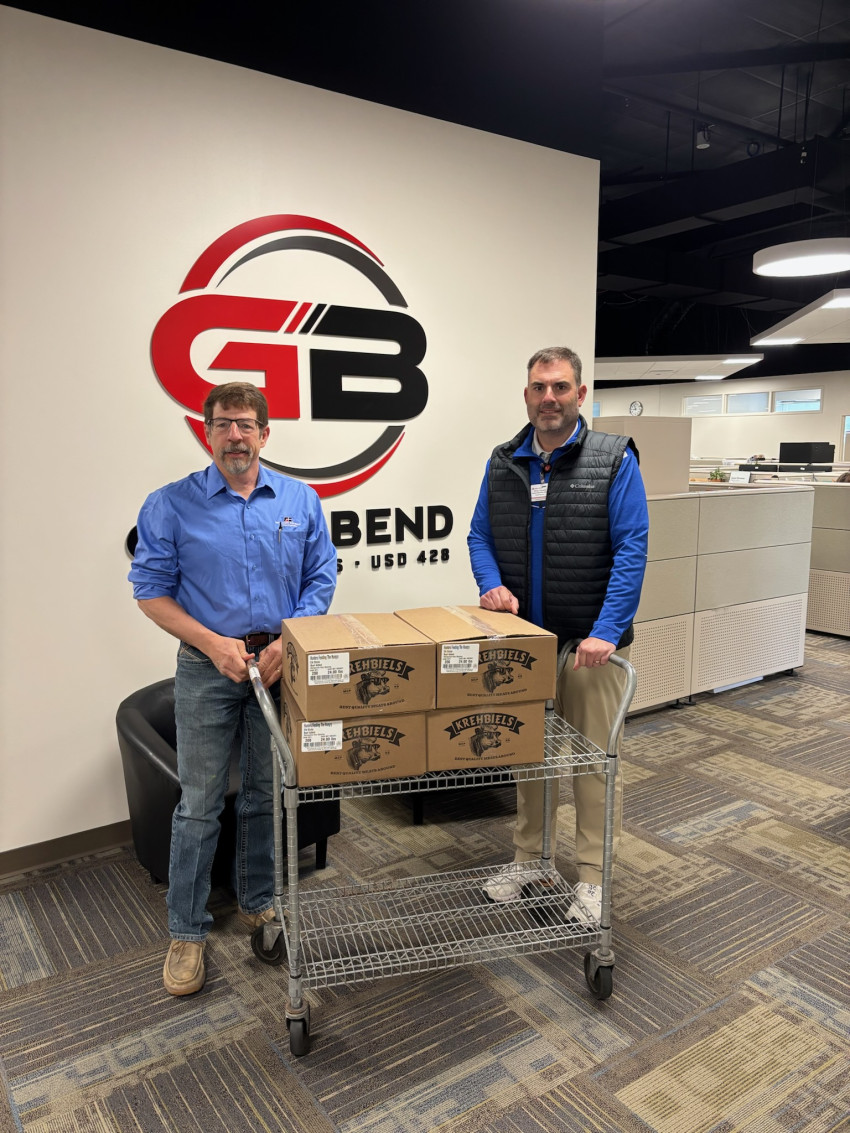 . Barton County Farm Bureau project chairman, Roger Long, presents Superintendent Chris Thaxton with cartons of snack sticks. Barton County Farm Bureau project chairman, Roger Long, presents Superintendent Chris Thaxton with cartons of elk snack sticks.