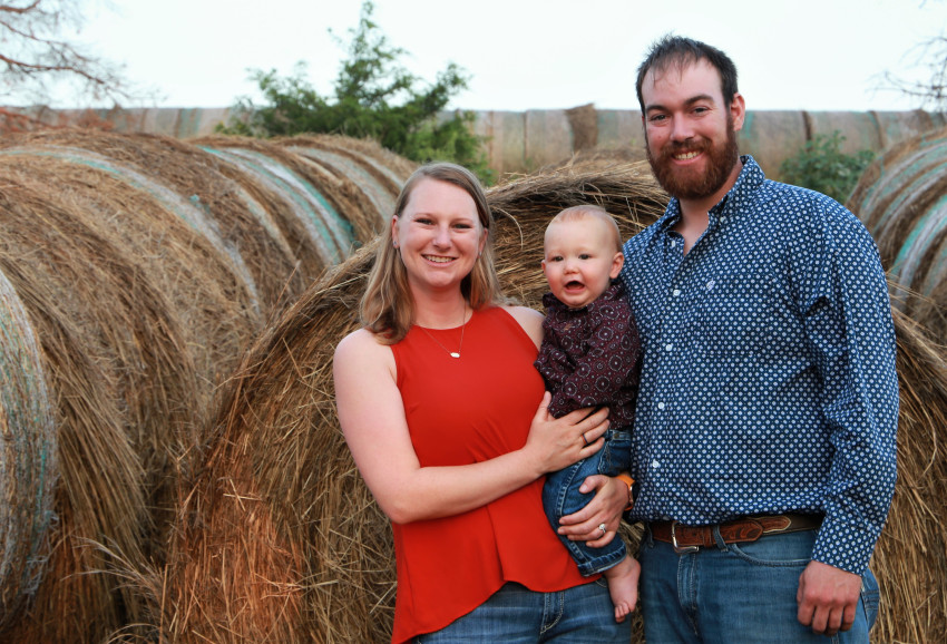 carpenter ranch family in front of hay