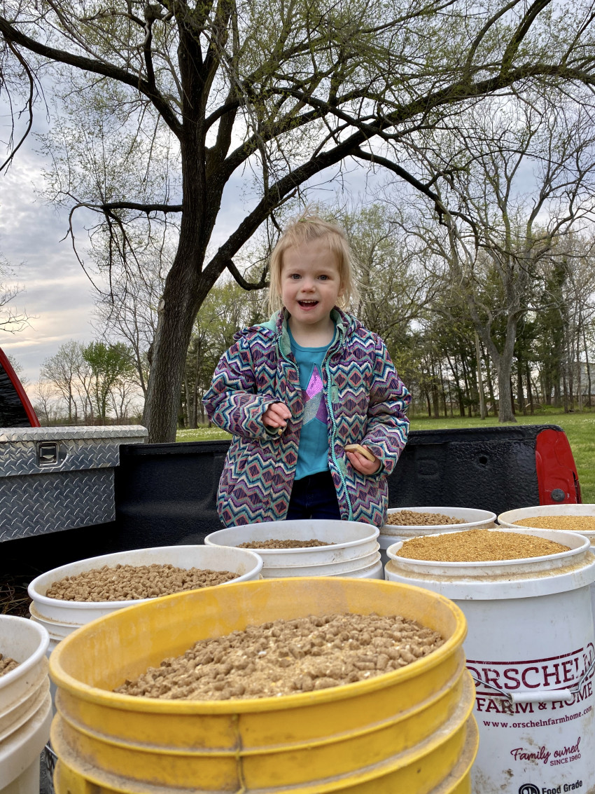 Brandi's daughter with feed buckets