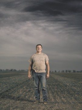 farmer standing in dormant field