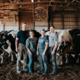 The Rokeys stand outside with Holstein dairy cows