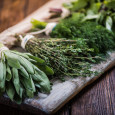 fresh herbs for cooking on wooden cutting board