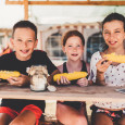Kids eating sweet corn
