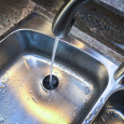water running down kitchen sink into garbage disposal