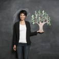 Woman standing next to a money tree