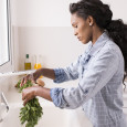 woman washing fresh herbs
